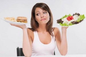 Woman-choosing-between-a-hamburger-plate-and-a-salad-plate